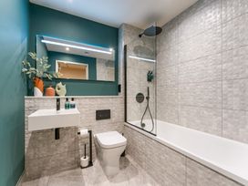 A bathroom with a shower and bathtub at Hidden 19- Coastal Hot Tub, St Ives