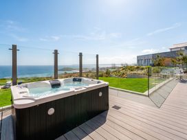 An outdoor hot tub with ocean view at Hidden 19- Coastal Hot Tub in St Ives