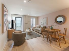 A living room with a sofa and dining area at tbc in St. Ives