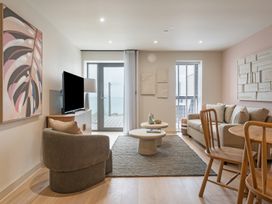 A living room with a television and sofa at tbc in St. Ives