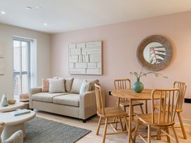 A living room with a sofa and dining table at tbc in St. Ives