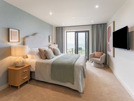 A bedroom with a bed and nightstand at tbc in St. Ives