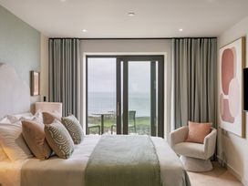 A bedroom with a bed and view of the ocean at tbc St. Ives