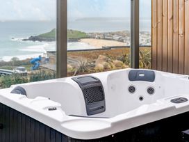 A hot tub with a view overlooking the beach at tbc in St. Ives