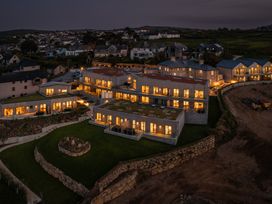 An outdoor view of illuminated buildings at Hidden 20- Gallery Hot Tub in St Ives