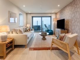 A living room with a sofa, coffee table, and television at tbc in St. Ives