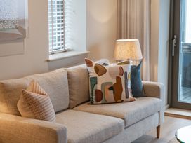 A living room with a sofa and pillows at tbc in St. Ives