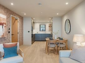 A living room with a kitchen area and dining table at tbc in St. Ives