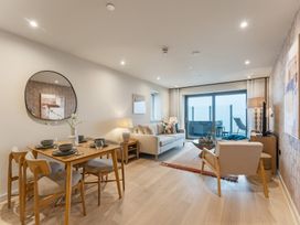 A living room with furniture and a television at tbc in St. Ives