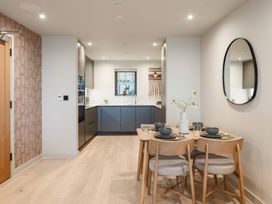 A dining area with a table and chairs in a kitchen at tbc in St. Ives