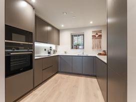 A kitchen with cabinets, oven and sink at tbc in St. Ives