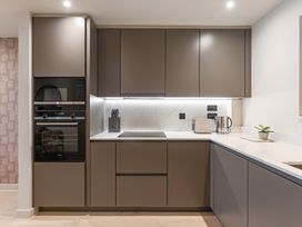 A kitchen with cabinets, stove, oven, kettle and toaster at tbc St. Ives