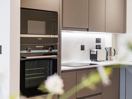 A kitchen with an oven and microwave at tbc in St. Ives