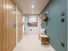 A hallway with doors and a bench at tbc in St. Ives