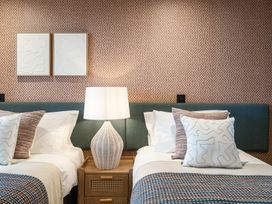 A bedroom with two beds and a lamp at tbc in St. Ives