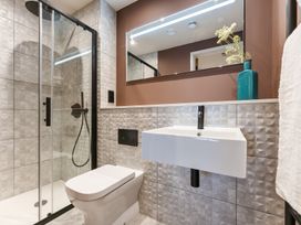 A bathroom with shower, toilet, and sink at The Old Barn in St. Ives