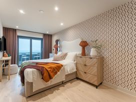 A bedroom with a bed and television at tbc in St. Ives