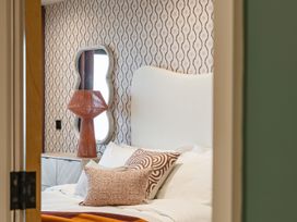 A bedroom with a bed and lamp at tbc St. Ives