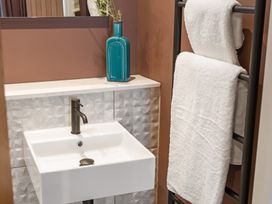 A bathroom with a sink and towels at tbc St. Ives