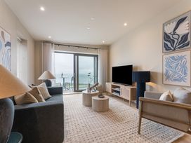 A living room with a television and sofa at tbc in St. Ives