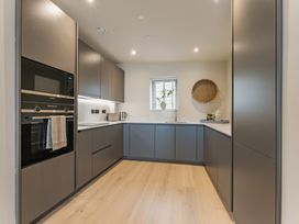 A kitchen with modern cabinets and appliances at tbc St. Ives
