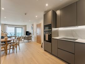 A living room with a dining area and kitchen features at tbc St. Ives