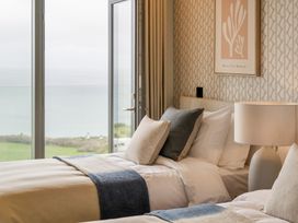 A bedroom with two beds and a view at tbc in St. Ives