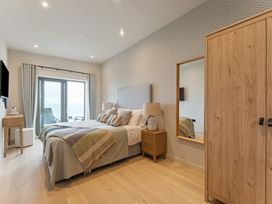 A bedroom with a bed and sliding doors at tbc in St. Ives