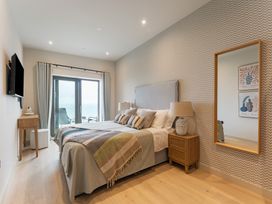 A bedroom with a bed and television at tbc in St. Ives