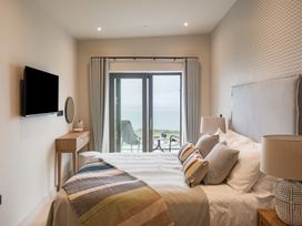 A bedroom with a bed and sliding door at tbc in St. Ives