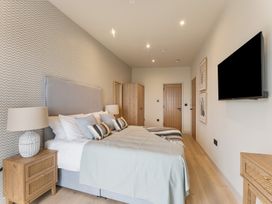 A bedroom with a bed and side tables at tbc in St. Ives