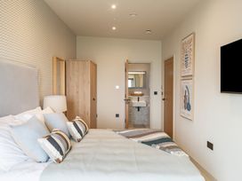 A bedroom with a bed and wardrobe at tbc in St. Ives