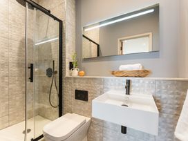 A bathroom with a shower, toilet, and sink at tbc in St. Ives