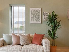 A living room with a sofa and decorative items at tbc in St. Ives