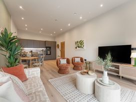 A living room with a sofa and dining area at tbc in St. Ives