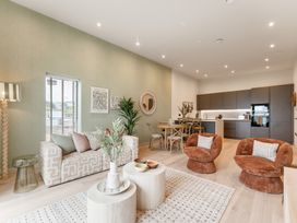 A living room with a sofa and kitchen area at tbc in St. Ives