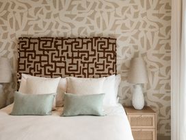 A bedroom with a bed and decorative headboard at tbc St. Ives