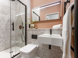 A bathroom with a shower, toilet, and sink at tbc in St. Ives
