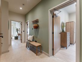 A hallway with a bench and doors at tbc in St. Ives