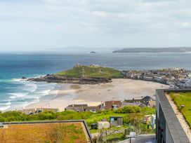 A view of a beach with houses and a hill at Hidden 10- Godrevy View, St Ives