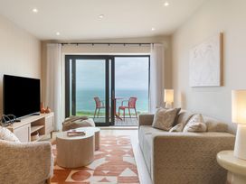 A living room with a sofa and a coffee table at Hidden 10- Godrevy View in St Ives