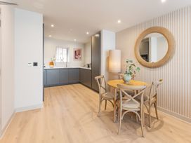 A dining room with a circular table and chairs at Hidden 10- Godrevy View in St Ives