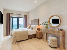 A bedroom with a bed and a window at Hidden 10- Godrevy View in St Ives