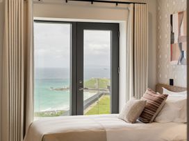 A bedroom with a view of the ocean at Hidden 10- Godrevy View, St Ives