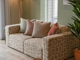 A living room with a sofa and cushions at tbc in St. Ives