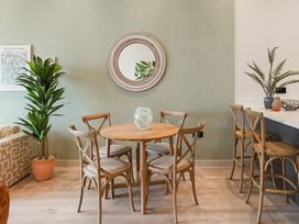 A dining room with a round table and chairs at tbc in St. Ives