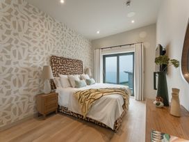 A bedroom with a bed and sliding door at tbc in St. Ives