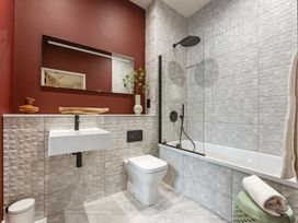 A bathroom with a bathtub and a sink at tbc in St. Ives
