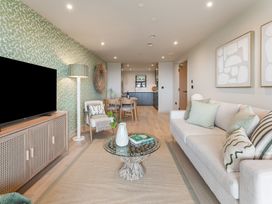 A living room with a television, sofa, and coffee table at tbc in St. Ives