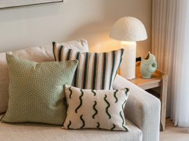 A living room with cushions and a lamp at tbc in St. Ives